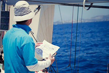 man on boat reading map